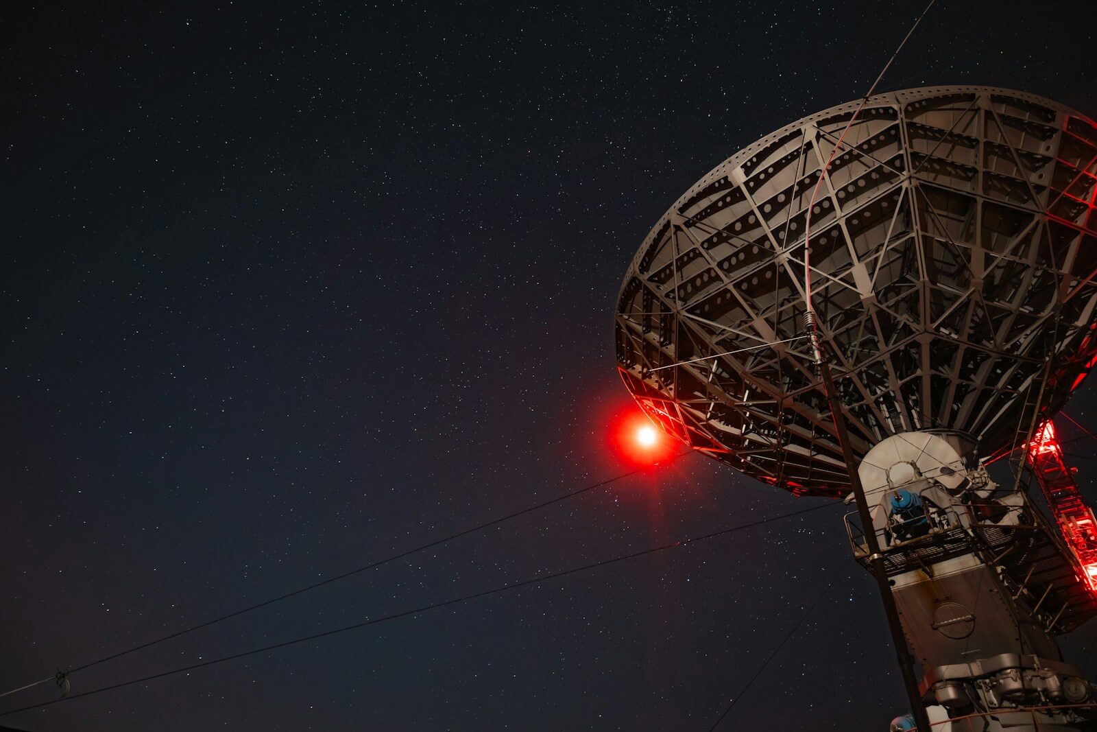 a radio tower with a red light on top of it